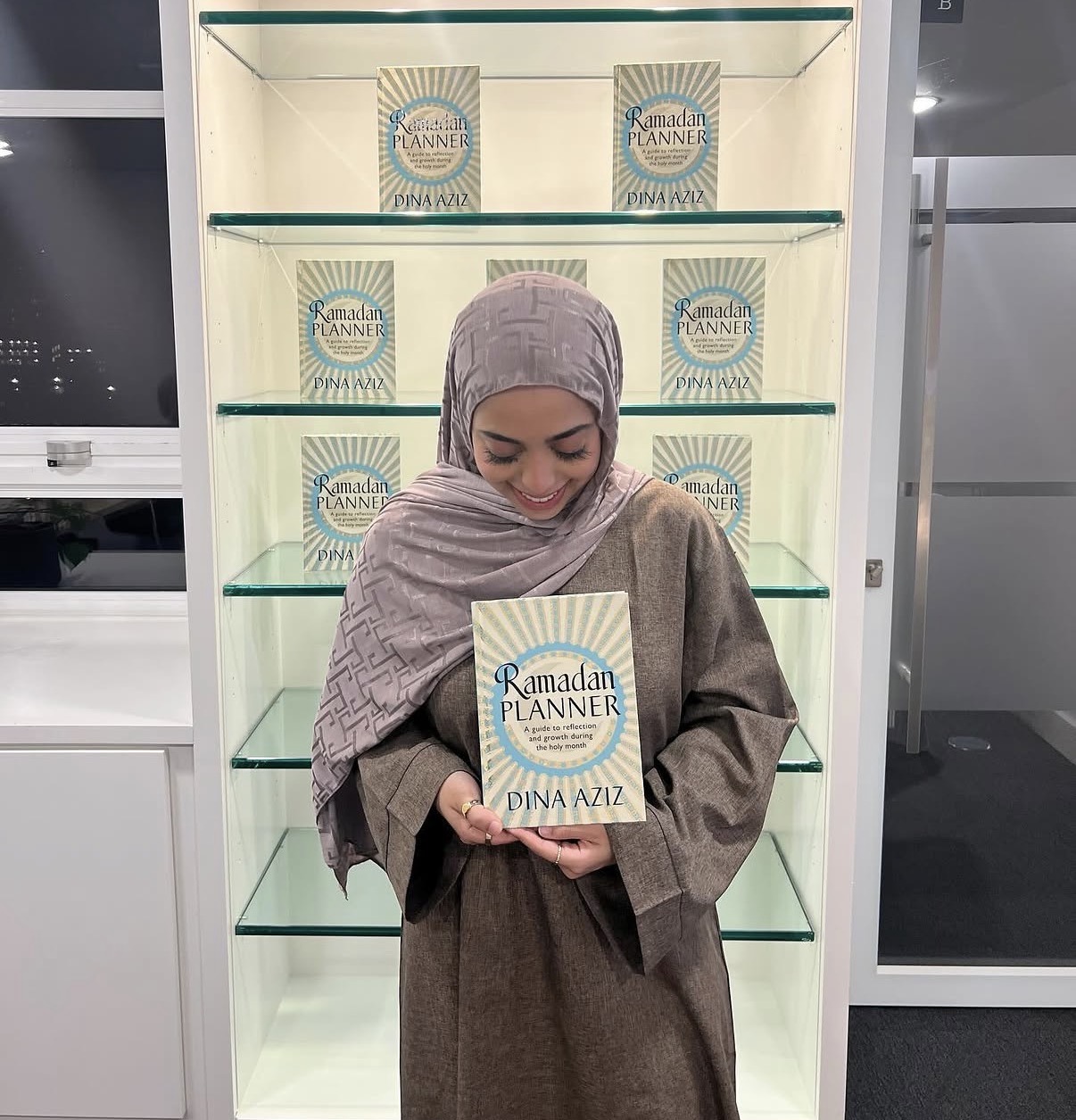 Dina Aziz holding the Ramadan Planner book
